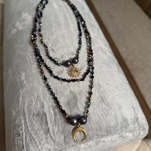 handmade, multi-strand, black and gold beaded necklace set with sun and moon